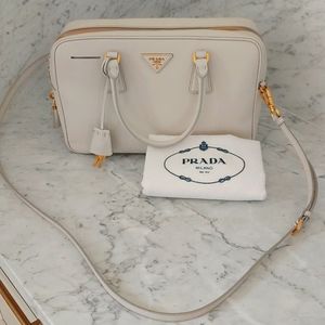 Prada handbag in Dove white color.